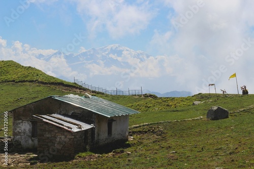 a hut in the panaar meadow with himalayan range in background of rudranath trek uttarakhand © deepak
