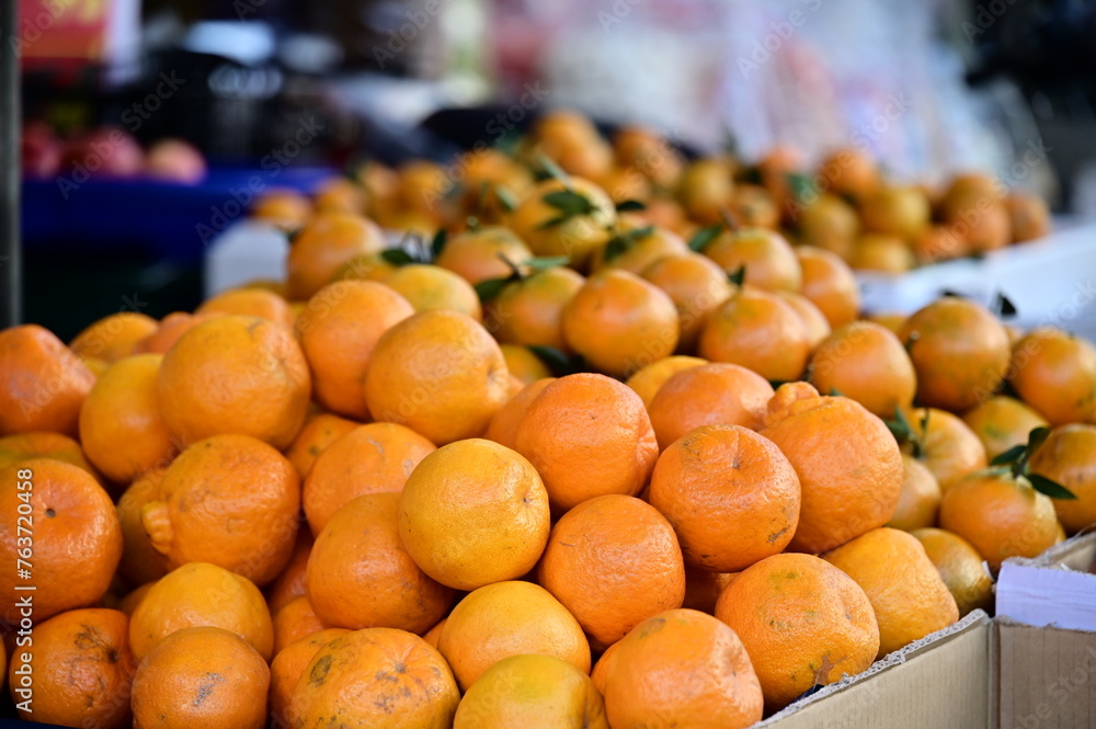 At a market stall features 
tangerine are rich in vitamin C and fiber., prized for their auspicious symbolism in Taiwan, especially during Lunar New Year. Tangerine are rich in vitamin C and fiber.