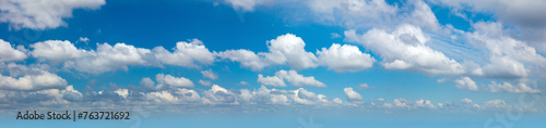 Panoramic sky - real blue sky during daytime with white light clouds Freedom and peace. Large photo format Cloudscape