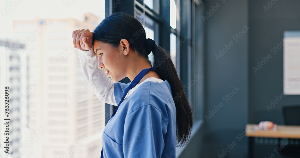 Nurse, healthcare and thinking at window of hospital with depression, medical decision and burnout. Medicine, woman and thoughtful professional doctor in clinic with mental health, stress and anxiety Nurse, healthcare and thinking at window of hospital with depression, medical decision and burnout. Medicine, woman and thoughtful professional doctor in clinic with mental health, stress and anxiety