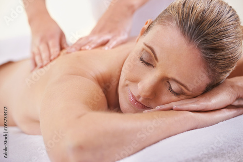 Girl, relax and hands massage in spa, wellness and resting in hotel or lodge. Physical therapy, holistic and female person in holiday or vacation in California for health, peace and back skin detox