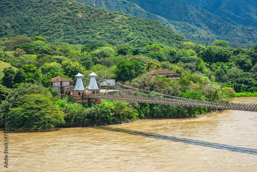 Scenic view of the historic Western Bridge in Santa Fe de Antioquia, Colombia, surrounded by lush greenery and mountains photo