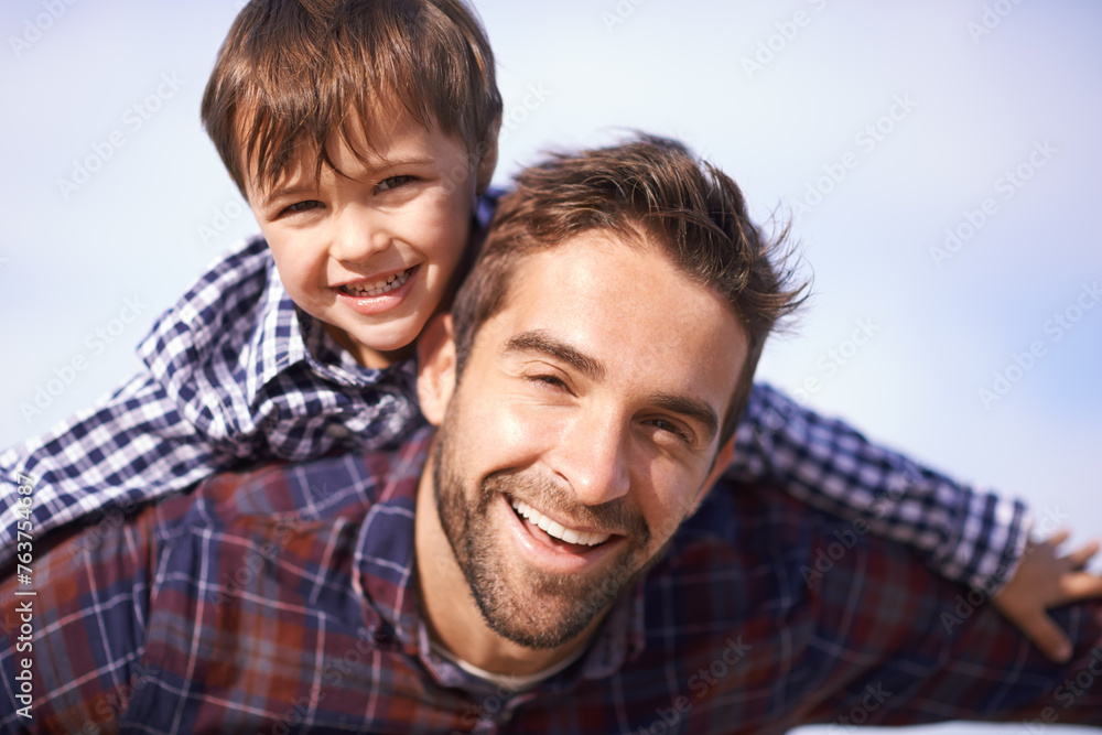 Portrait, man and child with piggy back, smile and playful travel to relax on outdoor adventure. Support, face of father and son in nature for fun bonding, playing and happy trust on holiday together Portrait, man and child with piggy back, smile and playful travel to relax on outdoor adventure. Support, face of father and son in nature for fun bonding, playing and happy trust on holiday together
