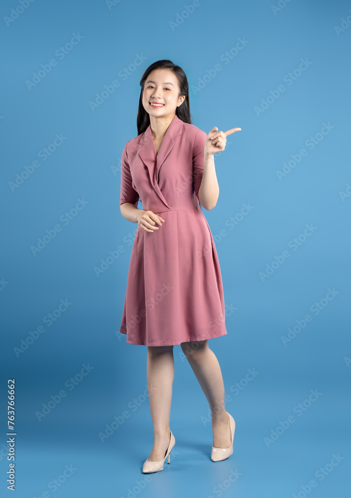 Full body image of female businessman posing on a blue background Full body image of female businessman posing on a blue background