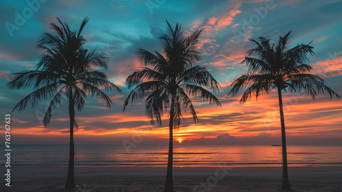 A tranquil beach sunset with palm trees silhouetted against the colorful sky photography