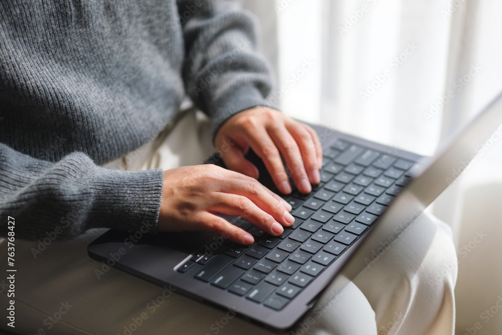 Closeup image of a woman typing on laptop computer keyboard Closeup image of a woman typing on laptop computer keyboard