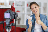 woman making thumbs up gesture while filming crafts blog