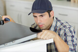a man installing kitchen worktop