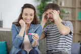 couple reacting to pregnancy test results