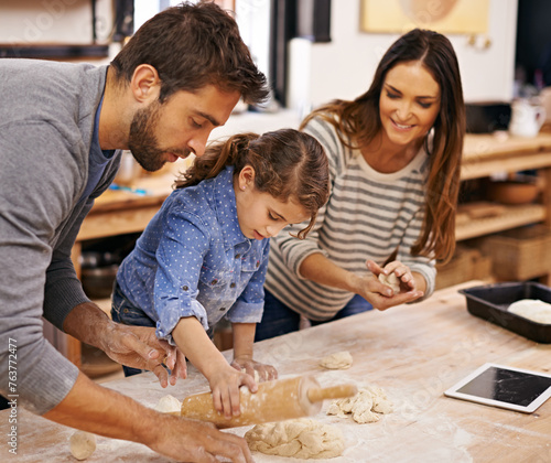 Pizza, dough and parents with child in kitchen and tablet for recipe, guide and learning together. Family, cooking and girl help with rolling pin and baking with dad and mom in home for dinner