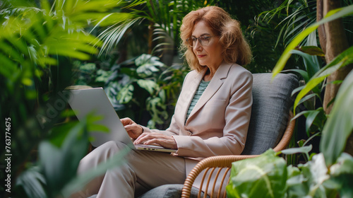 Elegant business woman in sunny office with green plants.