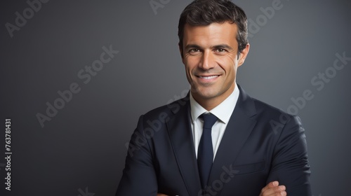 A man in a suit and tie is smiling and looking at the camera