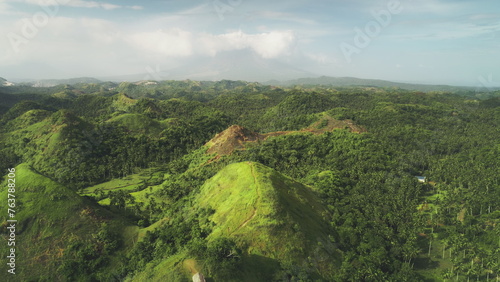 Aerial Philippines hill landscape: nobody wild nature with green tropic forest, abudant plant, high grass, lush mosses. Beautiful asian landmark natural wonder cinematic shooting in drone shot