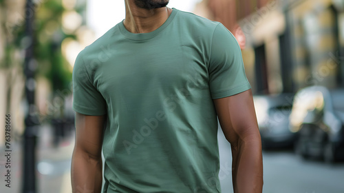 mockup showcasing a faceless man dressed in a stylish green t-shirt, walking confidently along a vibrant city street, exuding urban chic and modern allure amidst the bustling cityscape