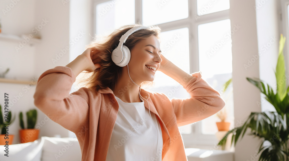 Joyful Young Woman Dancing Alone in a Bright Living Room, Enjoying Music with Wireless Headphones, Exuding Happiness and Freedom Joyful Young Woman Dancing Alone in a Bright Living Room, Enjoying Music with Wireless Headphones, Exuding Happiness and Freedom