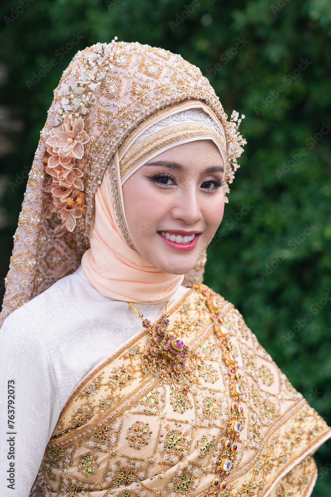 Islamic bride in hijab, Portrait of Muslim bride in traditional islamic-Lanna Style wedding dress looking at camera Islamic bride in hijab, Portrait of Muslim bride in traditional islamic-Lanna Style wedding dress looking at camera