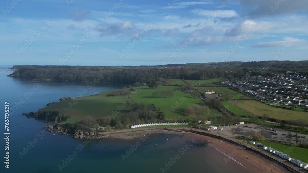 Broadsands, Torbay, South Devon, England: DRONE VIEWS: Tilt up from beach huts; sea; Torbay coastline; sandy beach and houses. Torbay is a popular UK holiday resort ( Clip 2). Broadsands, Torbay, South Devon, England: DRONE VIEWS: Tilt up from beach huts; sea; Torbay coastline; sandy beach and houses. Torbay is a popular UK holiday resort ( Clip 2).