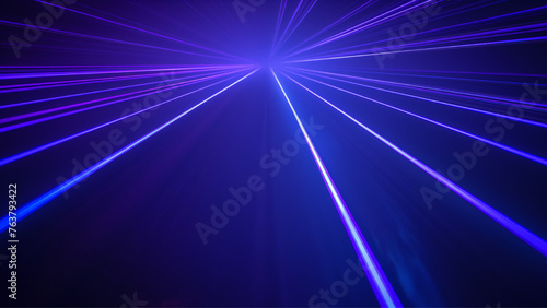 blue and violet beams of bright laser light shining on black background