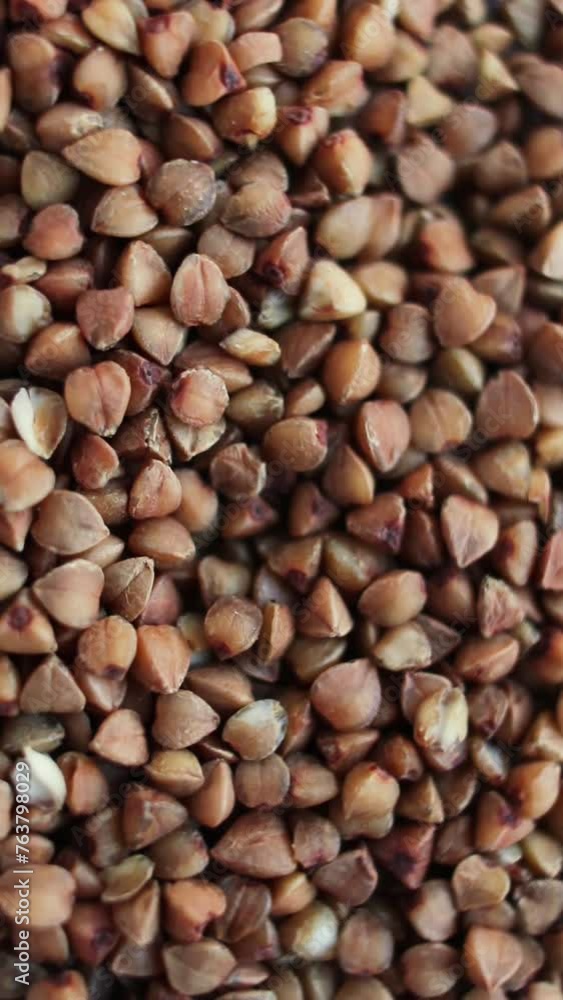 Buckwheat grains background. Raw Large Buckwheat Grains. Vertical video. Buckwheat grains background. Raw Large Buckwheat Grains. Vertical video.