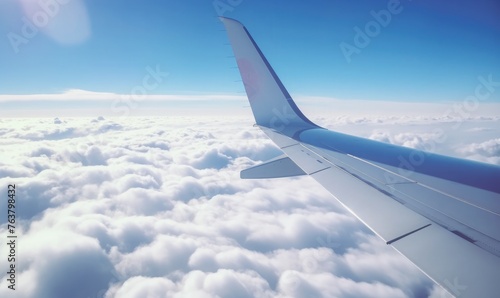 airplane's wingtip as it slices through the clouds during flight 