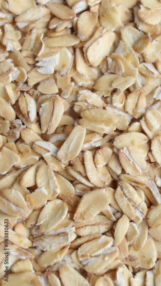 Background of oats grains rotating close up, top view. Vertical video. Background of oats grains rotating close up, top view. Vertical video.