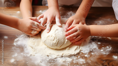 Children's Hands Kneading Dough on Wooden Table
