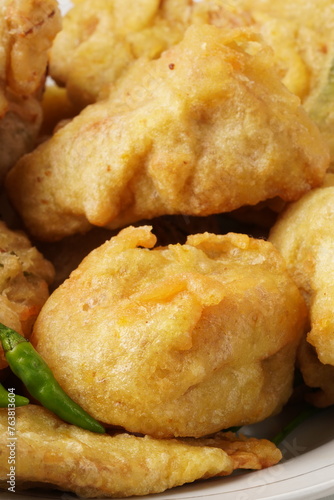 One of Indonesia's favorite fried snacks, 'tahu isi', features white tofu stuffed with vegetables like carrots and bean sprouts, then deep-fried in a crispy batter.