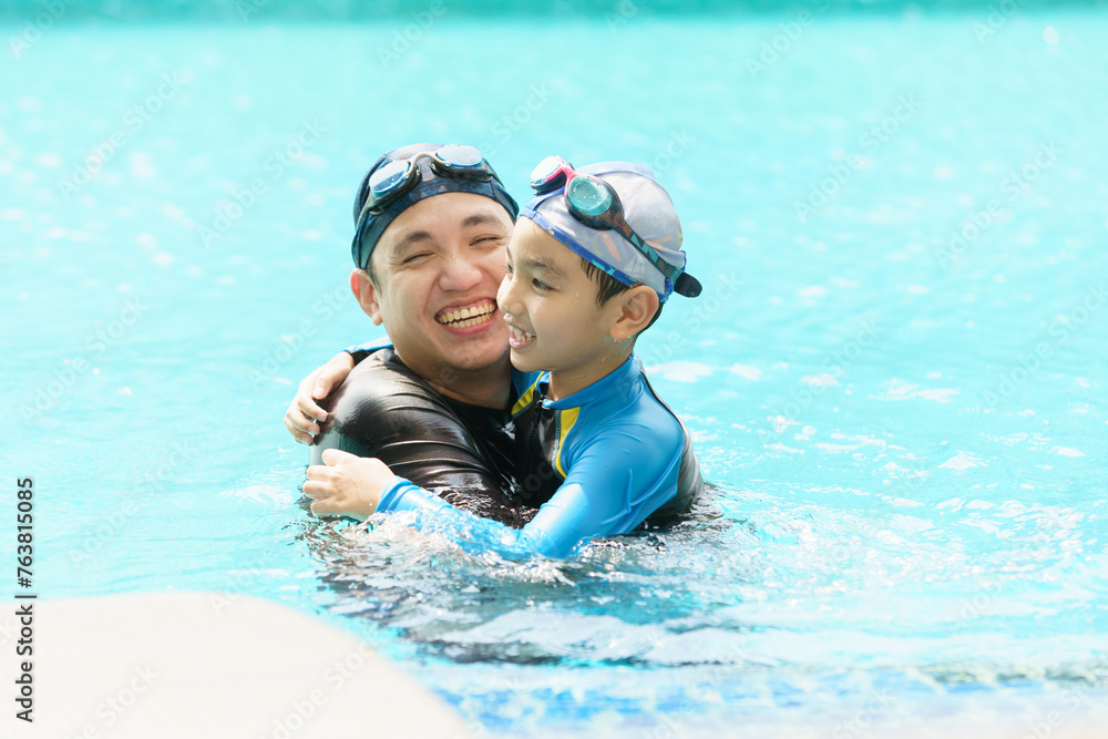 Father and son enjoy swimming together on their vacation.
