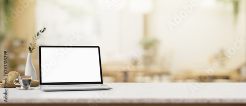 Wallpaper Mural A white-screen laptop computer mockup on a white table in a cosy coffee shop. Torontodigital.ca