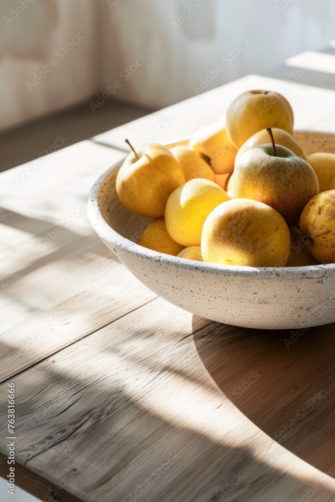 Sunlight Bathes a Plate of Fresh Apples on a Wooden Table in a Serene Indoor Setting