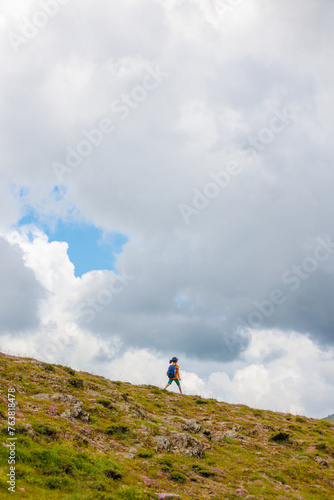 Traveling child. a tourist with a backpack walks along a mountain road. hiking and active healthy lifestyle.