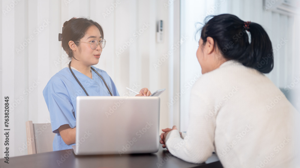 Fototapeta premium A professional Asian female doctor is consulting a female patient in the office at the hospital.