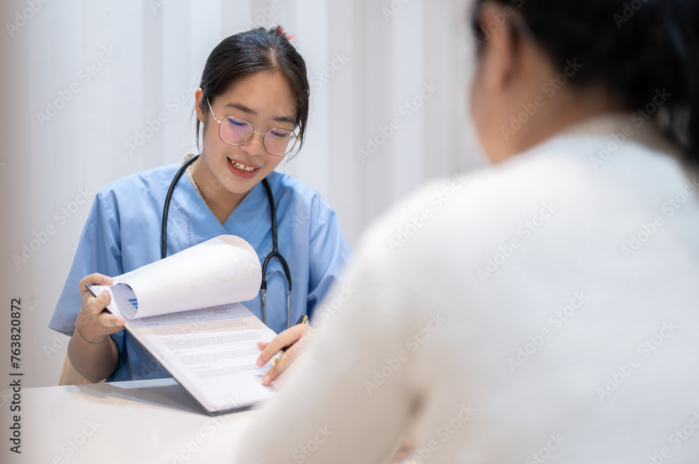 A doctor showing reports and giving advice to a patient during a medical check-up at the hospital. A doctor showing reports and giving advice to a patient during a medical check-up at the hospital.