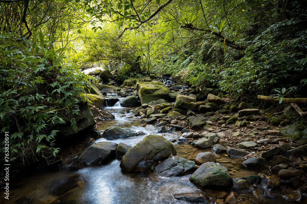 Lovely river hidden in the forest, round rocks on the stream, and sunlight shines on it, in New Taipei City, Taiwan. Lovely river hidden in the forest, round rocks on the stream, and sunlight shines on it, in New Taipei City, Taiwan.
