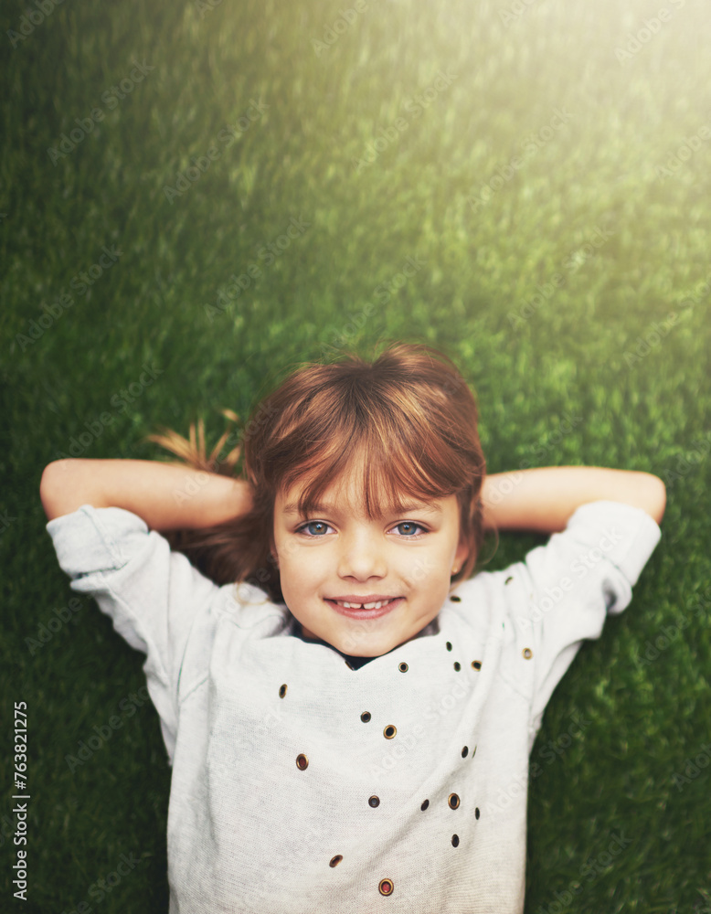 Happy, top view and portrait of child on grass for relaxing, playful fun and happiness in garden. Family, nature and above of young girl for childhood, playing and freedom on weekend outdoors Happy, top view and portrait of child on grass for relaxing, playful fun and happiness in garden. Family, nature and above of young girl for childhood, playing and freedom on weekend outdoors