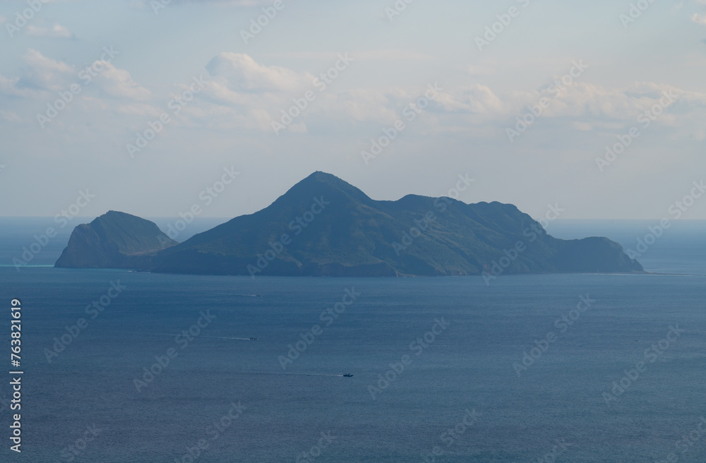 Misty day overlook Guishan Island standing on the ocean, shoot from the peak of hiking trail, in Yilan, Taiwan. Misty day overlook Guishan Island standing on the ocean, shoot from the peak of hiking trail, in Yilan, Taiwan.