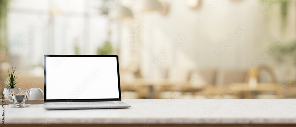 custom made wallpaper toronto digitalA laptop computer mockup on a table with a blurred background of a contemporary coffee shop.