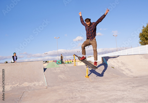 Fitness, freedom and man with skateboard, jump or rail balance at a skate park for stunt training. Energy, adrenaline and gen z male skater with air, sports or skill practice, exercise or performance