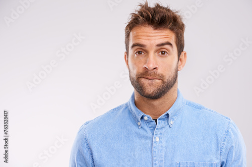 Studio, portrait and man with doubt, worry and confused on white background with mockup space. Opinion, disappointment and face of guy with decision, conflict or uncertainty for stress, news or ideas