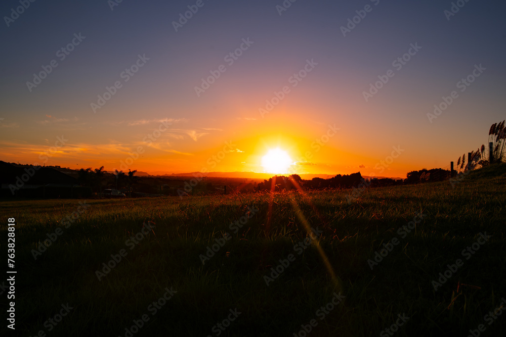 Sunset view in East Auckland in New Zealand. An Asian lady is walking around the neighborhood also. Sunset view in East Auckland in New Zealand. An Asian lady is walking around the neighborhood also.