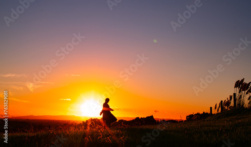 Sunset view in East Auckland in New Zealand. An Asian lady is walking around the neighborhood also. 