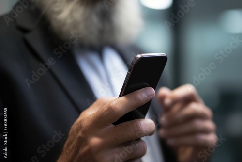 closeup shot of an unrecognisable man using a cellphone in the office