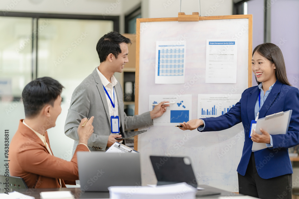 Asian business team having financial meeting with documents in office, having casual conversation in conference room. Business and office ideas Business team with laptop computers and documents