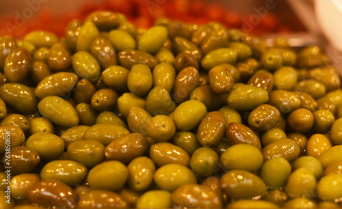 Green ripe olives close-up. Background of olives