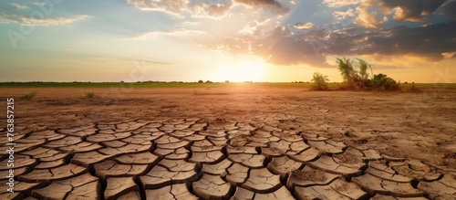 A barren field under a setting sun