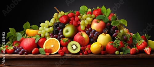 A pile of assorted fruits on a wooden table