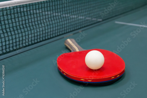 Table tennis ball and racket on the table - stock photo