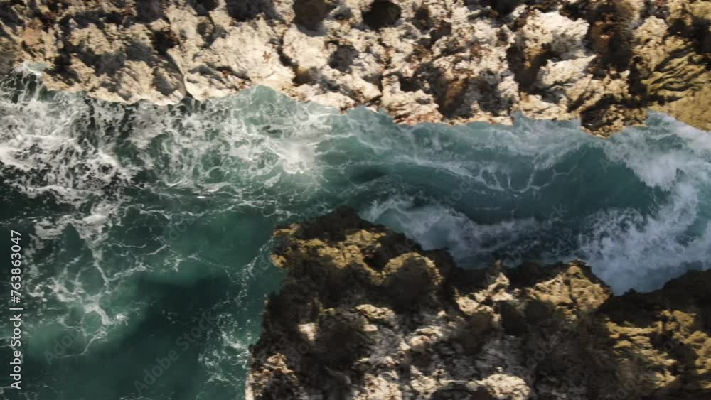 Aerial photography from a drone. Ocean waves crash against a crevice in the rocks.
Aerial photography from a drone. Ocean waves crash against a crevice in the rocks.