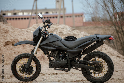 custom homemade motard enduro motorcycle for city and off-road riding in matte black color.