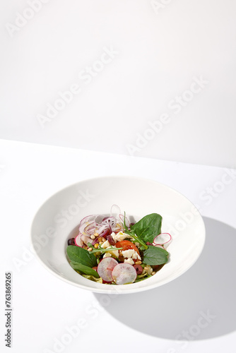 Greek salad isolated on a white background with crisp vegetables and feta cheese